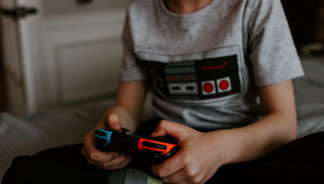 A photo of a child playing a video game, to represent the collaborative ESRC research project "Between Gaming and Gambling"